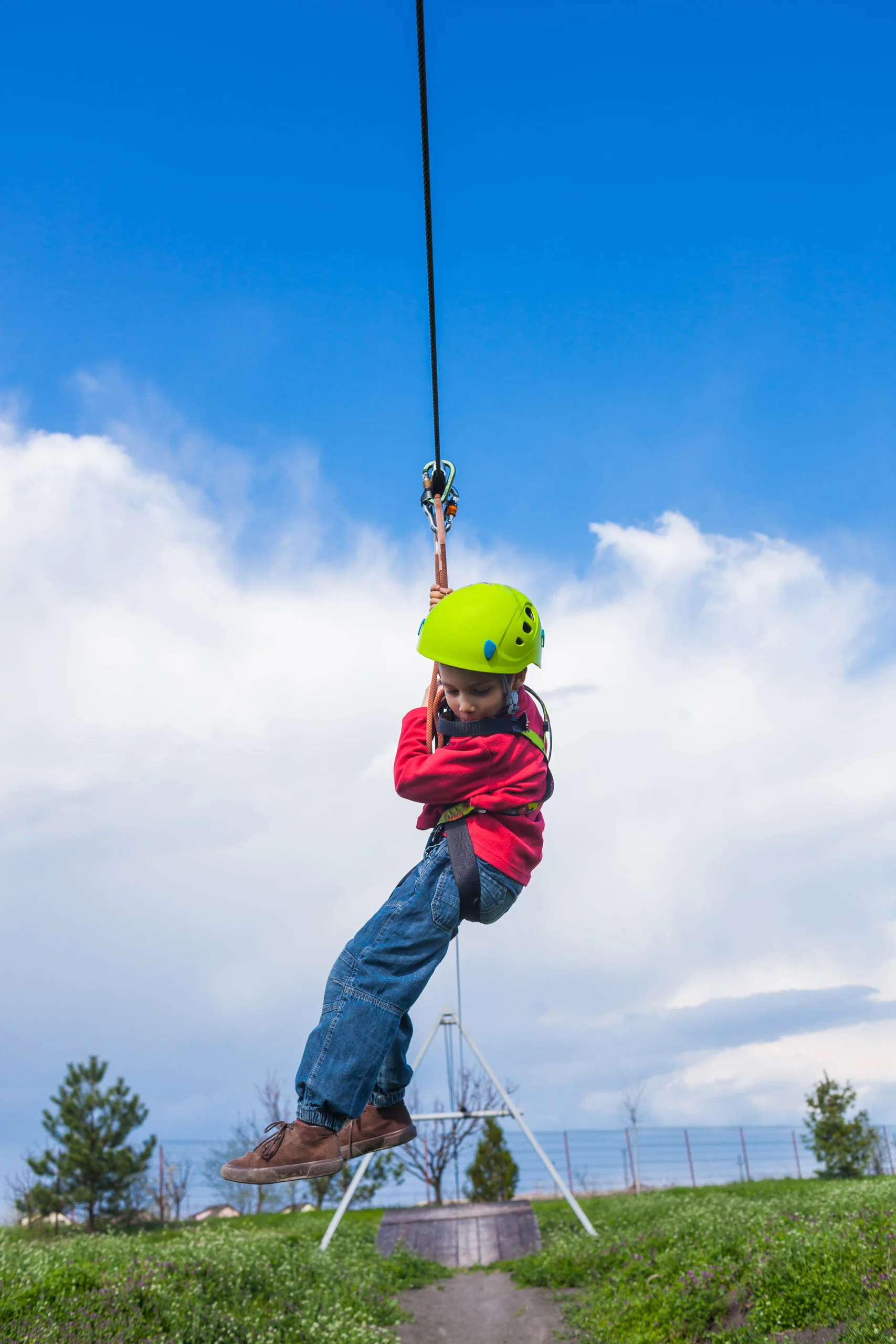 Boy sliding on zip line